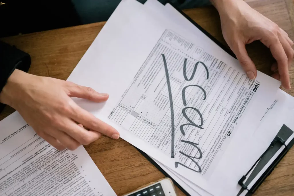Warning signs of a bridging loan scam in the UK — person reviewing suspicious documents